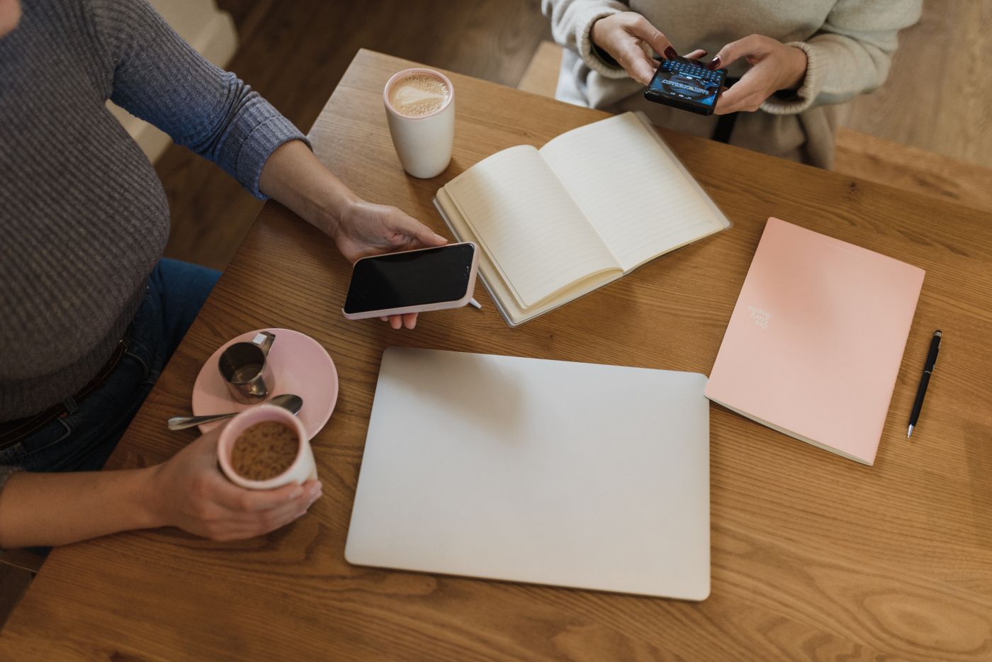 A cozy table with coffee, notebooks, and a pen, ready for planning.